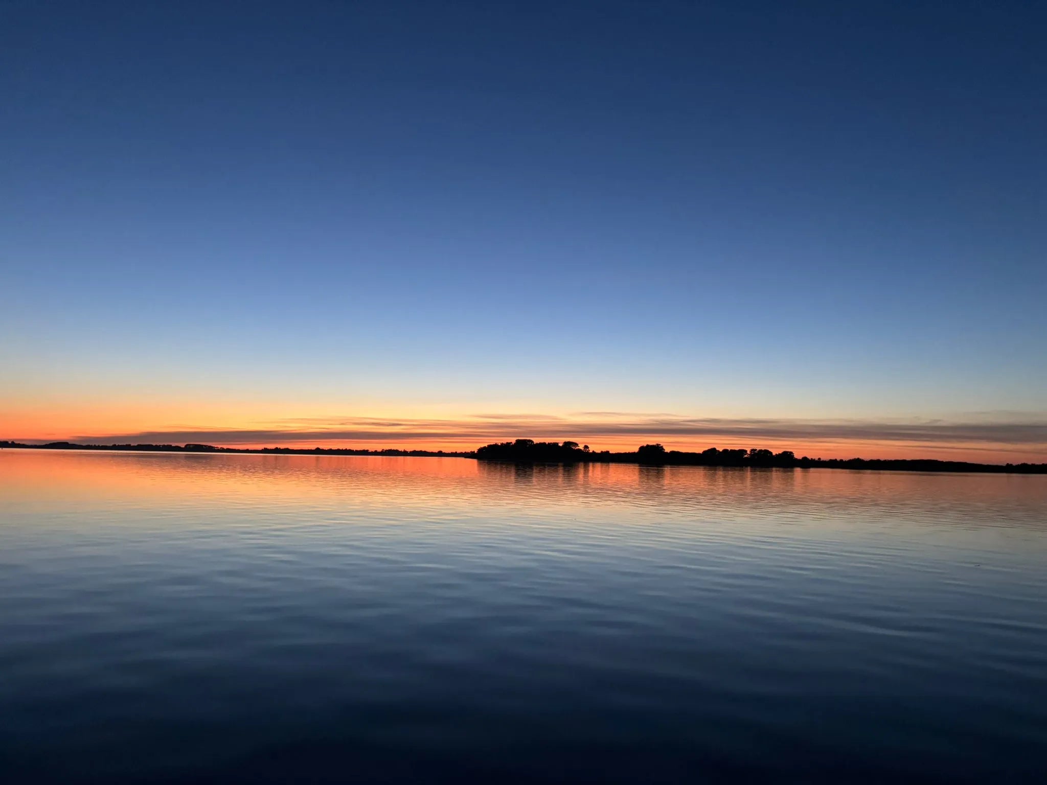 The golfe of Morbihan at dusk, Ile d'arz calm on the water